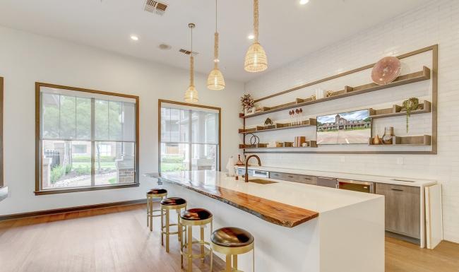 a kitchen with a bar and stools