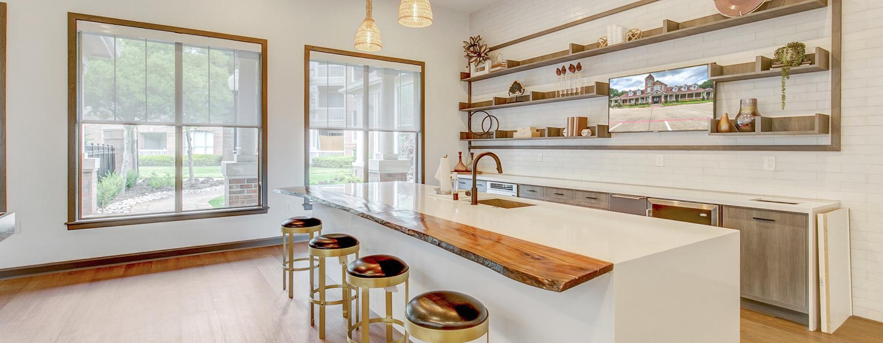 a kitchen with a bar and stools